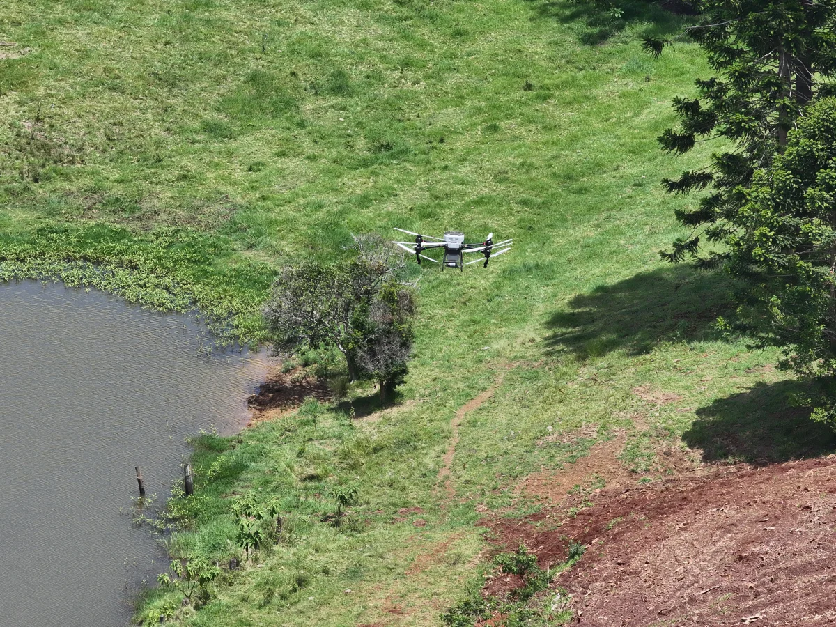 Agricultural drone performing aerial spraying operations
